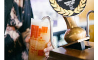 Close up of a ShAFF branded ale being poured into a ShAFF branded pint glass