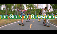 Film poster showing for young women riding longboards down the centre of a road lined by palm trees