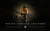 The poster image for the film Riding Through The Dark featuring a yellow jacketed cyclist riding towards the camera. The focus is on the cyclist with the background blurred out.