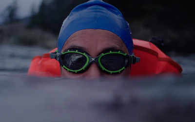 Close up of a swimmer staring at the camera with goggles on