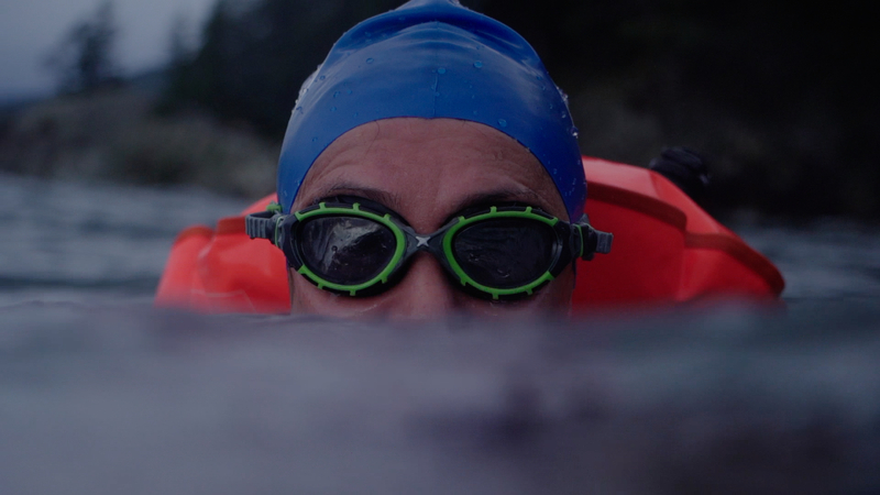 Close up of a swimmer staring at the camera with goggles on