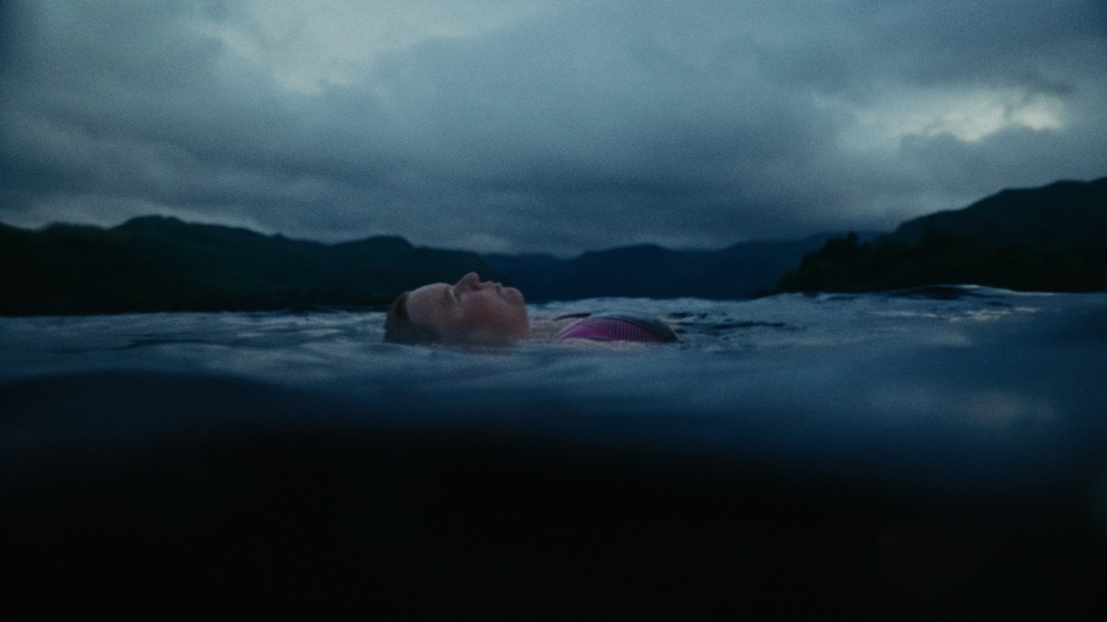 Nikki laying in the lake of the Lake District in the UK