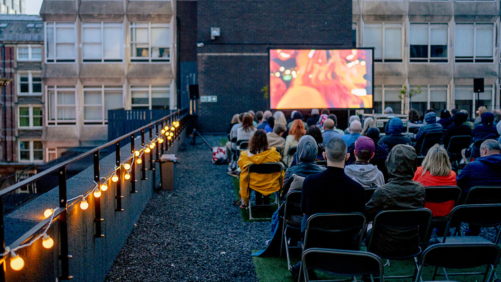 Audiences at a rooftop screening as part of FACT's Cinema in the City programme