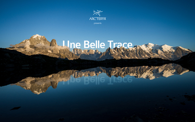 a mountain landscape behind a lake with the words Une Belle Trace above the mountains