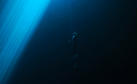 Helena Bourdillon freediving next to a light beam