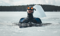 Freediving athlete Arthure G.B. prepares to dive under the ice.