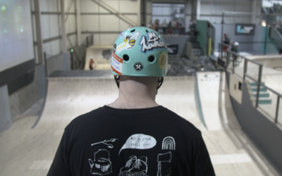 A rollerskater looking down a big ramp into a foam brick pit. Their t-shirt says 'all my friends skate here'