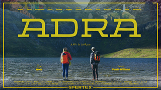 Two climbers face away from the camera at the edge of a body of water, looking across to a dark shady mountainous crag. Able the crag, other features of North Wales rise up, including colourful houses, a lighthouse, and more mountainous views. Faint text with journal entries from Pete's Eats can be seen across the image. Bright daffodil yellow text is laid across the image: ADRA, A film by Coldhouse. Featuring Zoe Wood, Lewis Perrin-Williams, Nick Bullock, Julie Carter, Rachel Crewesmith, Johnny Dawes, Tim Emmett, Alun Hughes, Mandy Glanvill, James McHaffie, Jim Perrin, Paul Pritchard, John Redhead, Ray Wood, Cathy Woodhead. In association with Everyfield Films. Director: Emma Crome. Co-director: Menna Wakeford. Executive Producer: Matt Pycroft. Producer: Harriet Sykes. Assistant Producers: Tim Burton & Orla O'Muiri. Cinematography: Matt Hardy, Ryan Goff, Roxanna Barry & Steve Wakeford. Safety: James McHaffie. Photography: Lena Drapella. Accessibility: Find It Film. Sound Design & Mix: We Are Audio. Sound Designers: Ruth Rainey & Jaz Harvey. Dubbing Mixer: Ben Mason. Sponsored by Pertex.