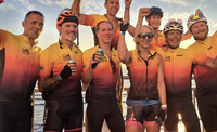 Group of cyclists celebrating at the finish of Chase The Sun