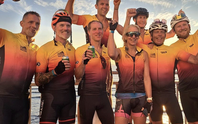Group of cyclists celebrating at the finish of Chase The Sun
