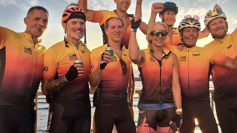 Group of cyclists celebrating at the finish of Chase The Sun