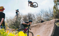 3 bicycle riders flying over the large set of jumps at Bolehills BMX track. 