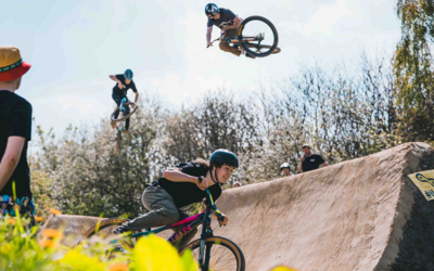 3 bicycle riders flying over the large set of jumps at Bolehills BMX track. 