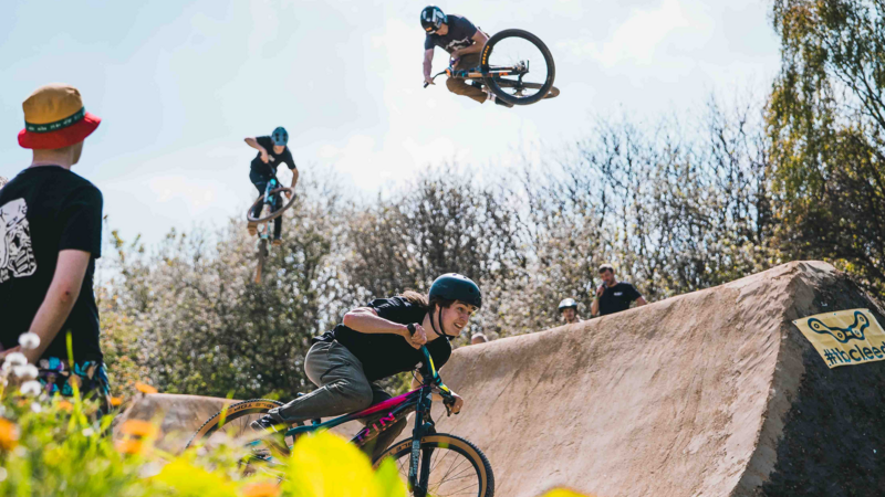 3 bicycle riders flying over the large set of jumps at Bolehills BMX track. 
