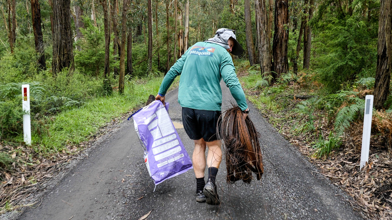 Beau Miles collects rubbish from the roadside.