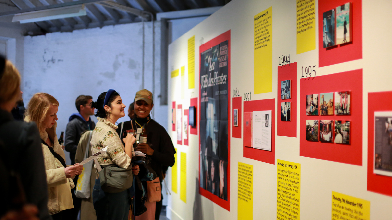 People looking at images on display in an exhibition at a film festival