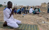 Abubakr, a young refugee from Sudan, praying.
