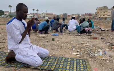Abubakr, a young refugee from Sudan, praying.
