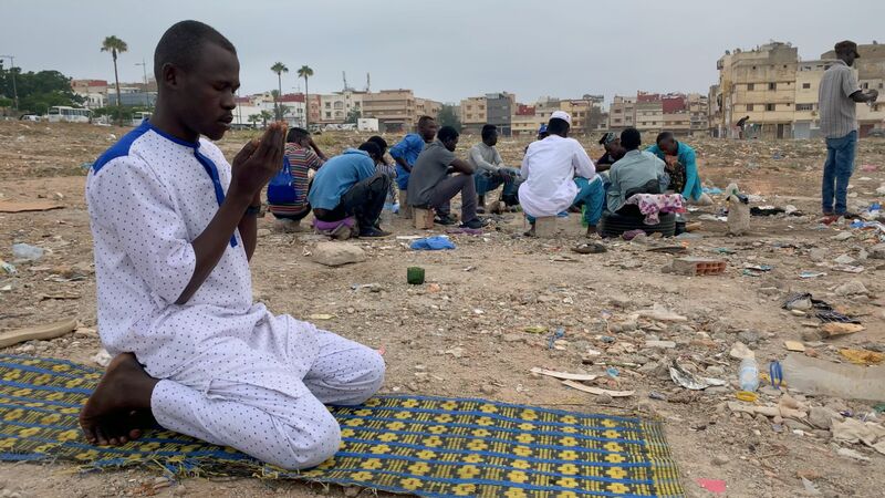 Abubakr, a young refugee from Sudan, praying.