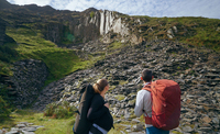 Angus Kille and heavily pregnant Hazel Findlay look up towards the distant Nant Peris Quarry