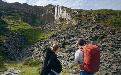 Angus Kille and heavily pregnant Hazel Findlay look up towards the distant Nant Peris Quarry