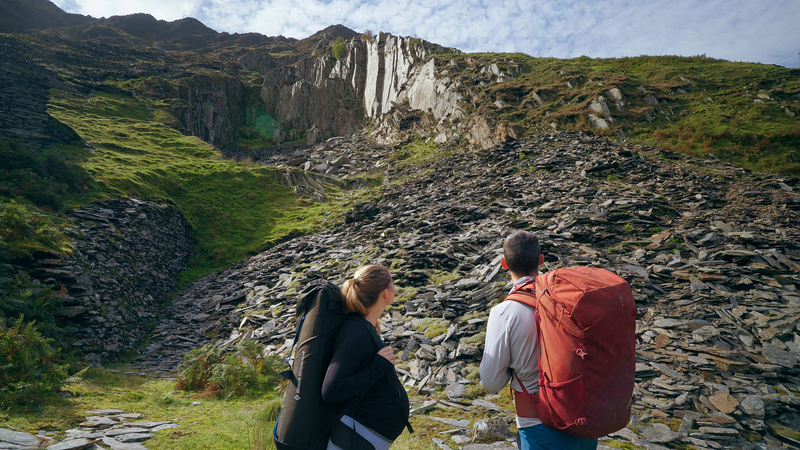 Angus Kille and heavily pregnant Hazel Findlay look up towards the distant Nant Peris Quarry