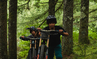 Film posters showing two mountain bikers pushing their bikes uphill