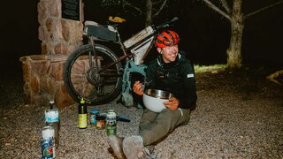 Justinas eating a big bowl of pasta to celebrate finishing the end of the Arizona Trail Bike Race.