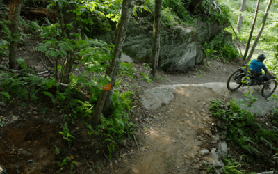Adaptive Rider Greg Durso at the top of a steep roll at world's first fully adaptive trail network, the Driving Range. 