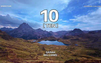 A picture of the mountains in France, with a lake in the middle. Large number 10 in the centre - with T E N underneath. 