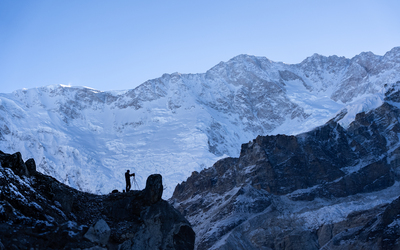Expedition leader Matt Sharman takes a photograph in front of the south face of Kangchenjunga