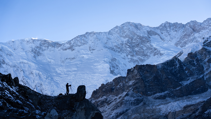 Expedition leader Matt Sharman takes a photograph in front of the south face of Kangchenjunga