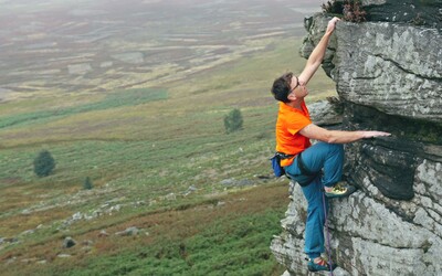 Climber at the top of a crag at stanage