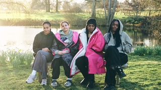 All four Swim Sistas sit on a bench