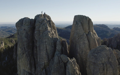 Two rock climbers on a summit in the Needles in South Dakota