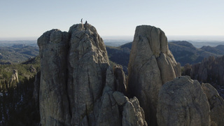 Two rock climbers on a summit in the Needles in South Dakota