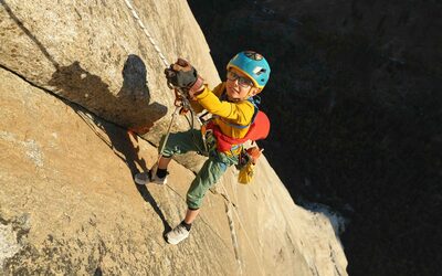 8yr old climber, Jackson Houlding, hangs from a rope as he jumars up the sheer rock face of El Capitan.