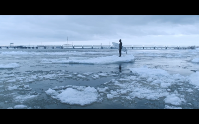 Orion navigating the ice field before surfing in the river.