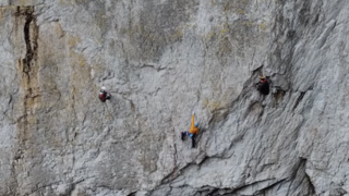 A man carefully navigates the exposed and sparsely protected route known as 'The Bells, The Bells!' (E7 6b) at Gogarth