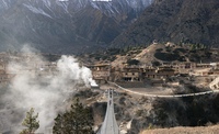 Kilian Bron and local childs on a suspension bridge in the remote Ringmo village, Dolpo, Nepal. 