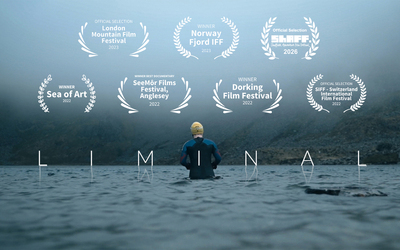 Embracing the cold before open water swimming in a Welsh mountain lake in winter