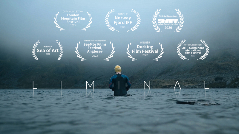 Embracing the cold before open water swimming in a Welsh mountain lake in winter