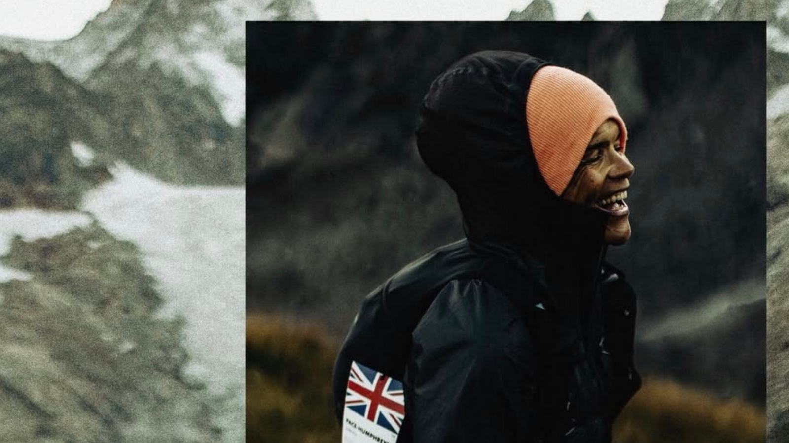 a person adorned in a black jacket and hood smiles